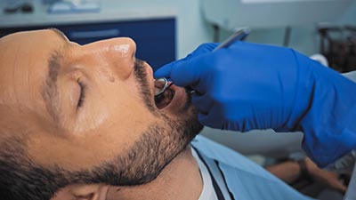 dentist performing root canal therapy on a patient in Denver, CO